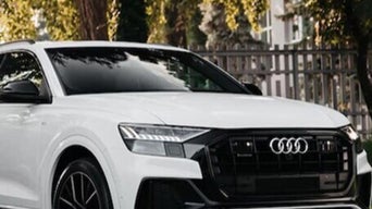 Three-quarter view of an Audi vehicle on the road.