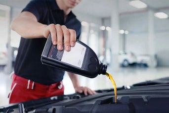 Service technician servicing vehicle.