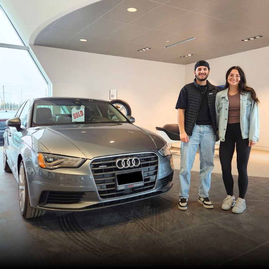 image of customers picking up their used Audi