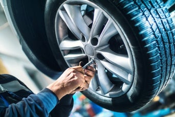 Vehicle technician working on a car's tires