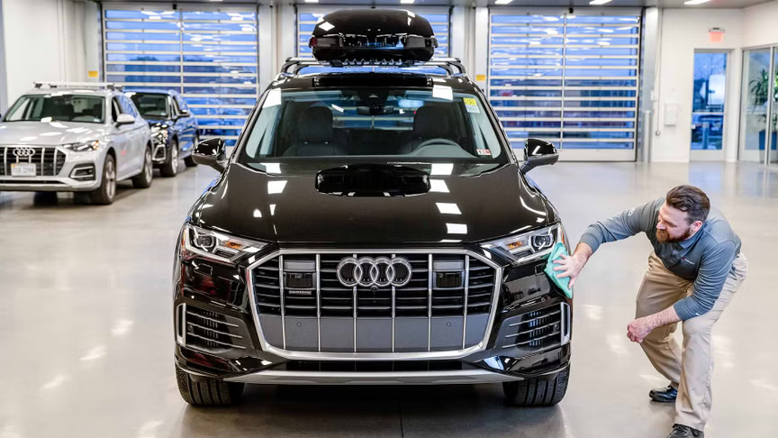 Customer inspecting vehicle at a Audi dealership in Santa Monica, CA