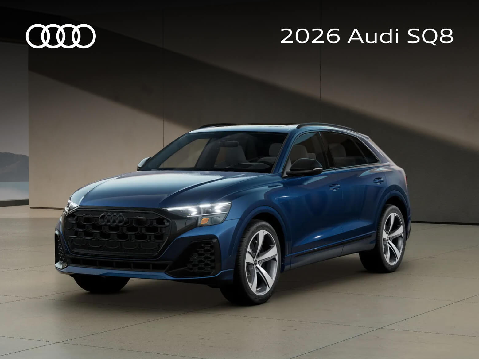 Exterior three-quarter view of a blue 2026 Audi SQ8 parked in front of a modern building at golden hour.