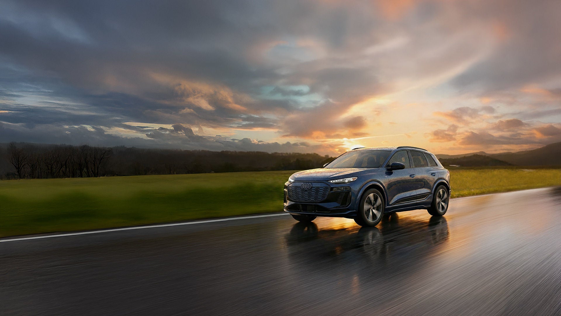 Front profile of an Audi Q6 e-tron accelerating.