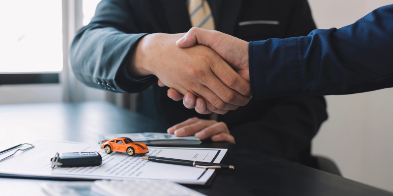 Audi employee handing a set of car keys to a customer.