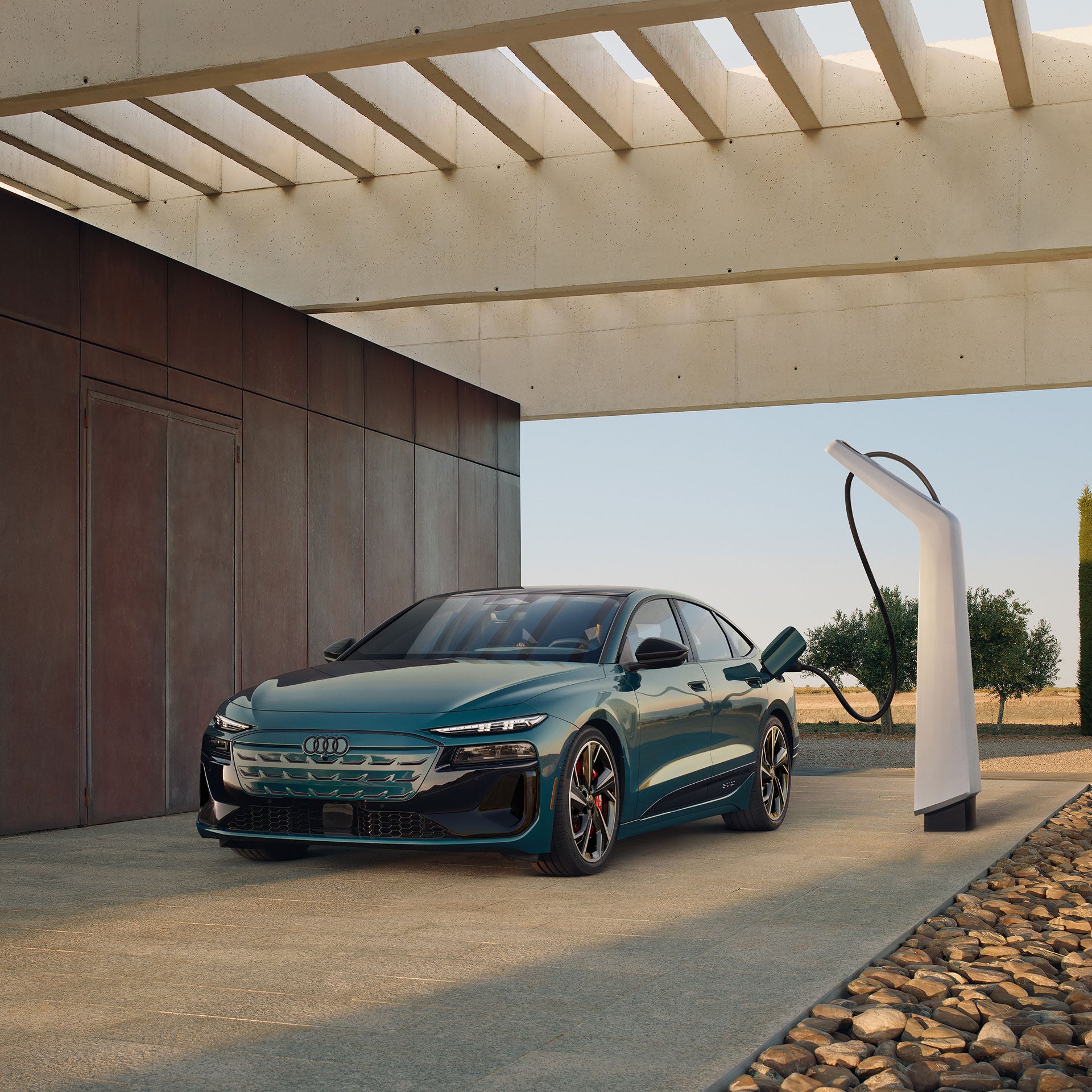 Three-quarter front view of the Audi S6 Sportback e-tron charging. 