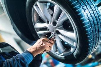 Service technician servicing tire.