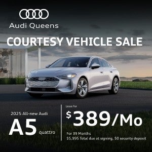 Front quarter view of Audi A5 driving.