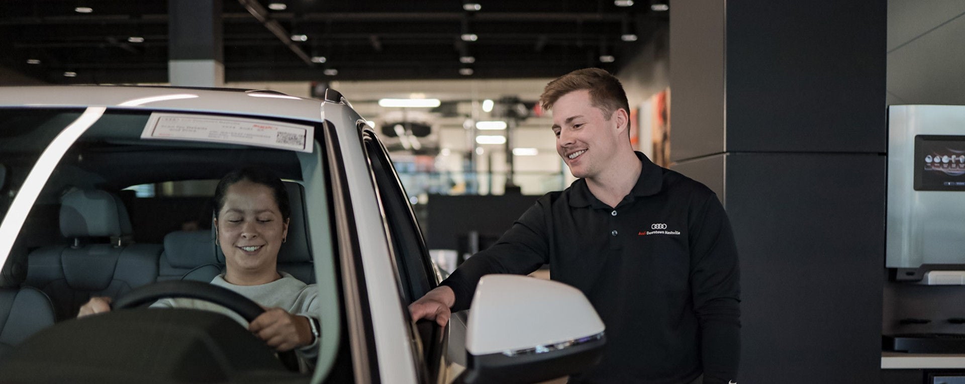 Audi Sale Specialist walking through the showroom with a couple.