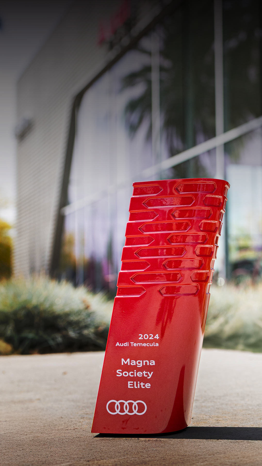 Audi Magna elite award in front of Audi Temecula building 