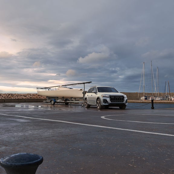 The Audi Q7 with a boat attached to the tow hitch.