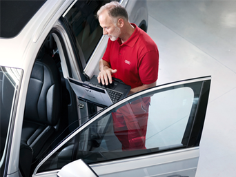 Service technician serving vehicle.