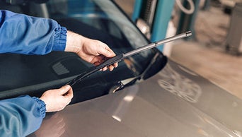 Technician installing a wiper blade
