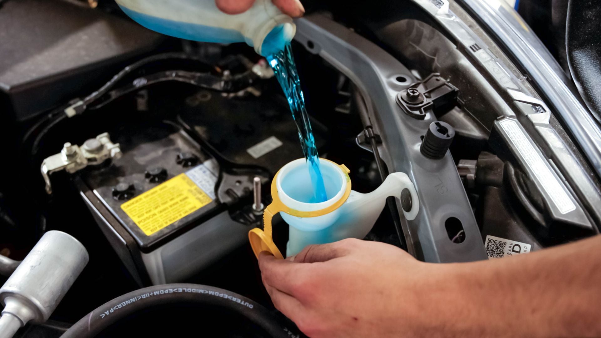 Audi service technician servicing a vehicle.