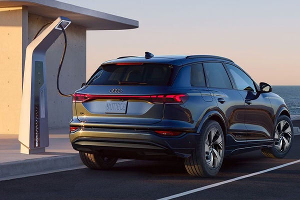 Side view of an Audi SUV charging.