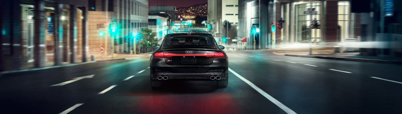 Rear view of 2025 Audi S7 in night city lights