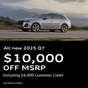 Side view of an Audi Q7 driving.