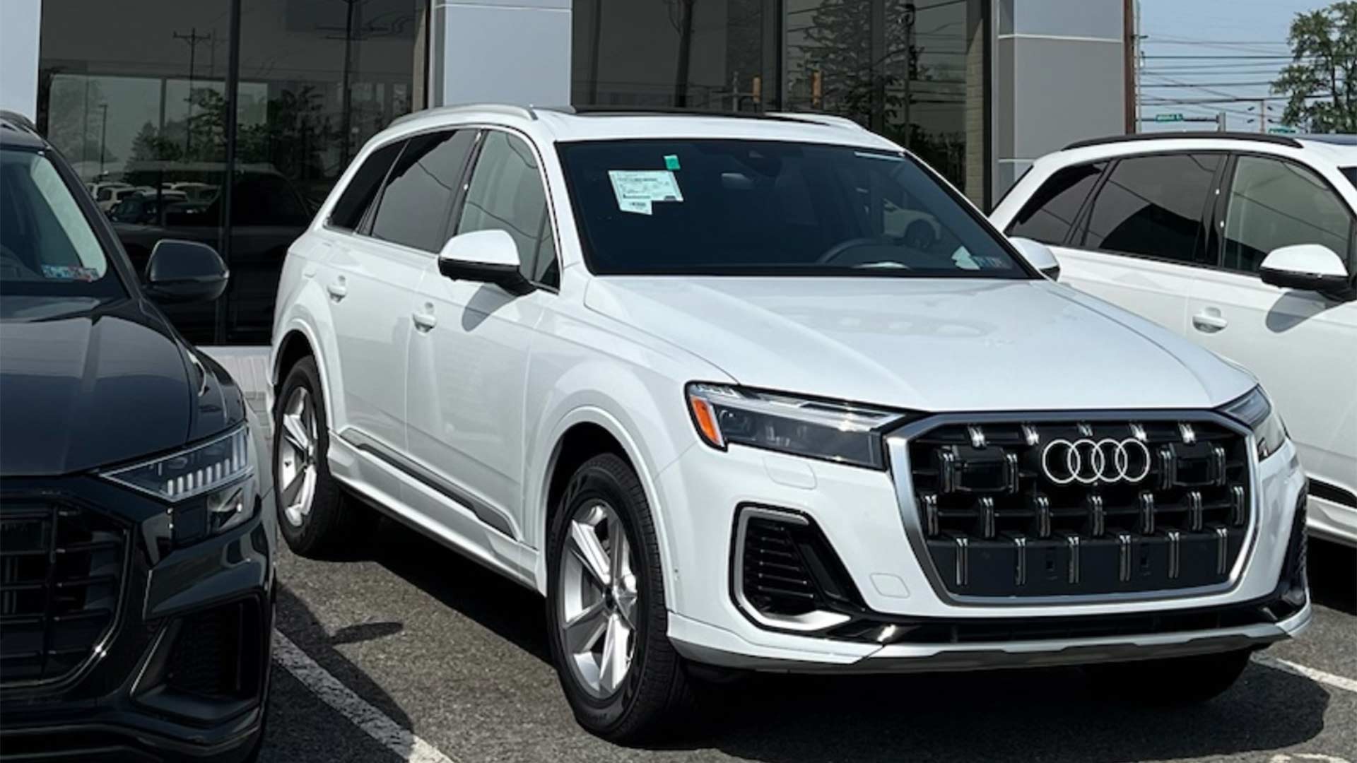 Audi employee handing a set of car keys to a customer.