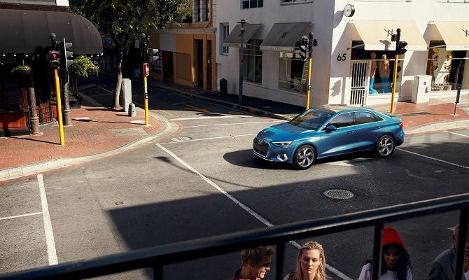 Audi A3 driving through a neighborhood