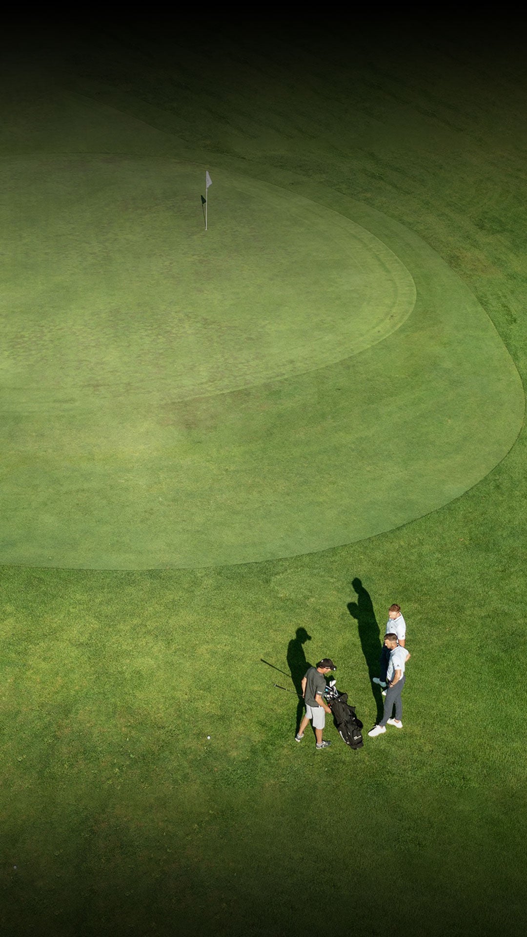 Aerial photo of three men on a golf course.