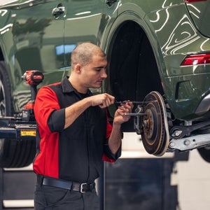 Audi service technician servicing an Audi.