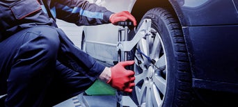 Service technician servicing tire.