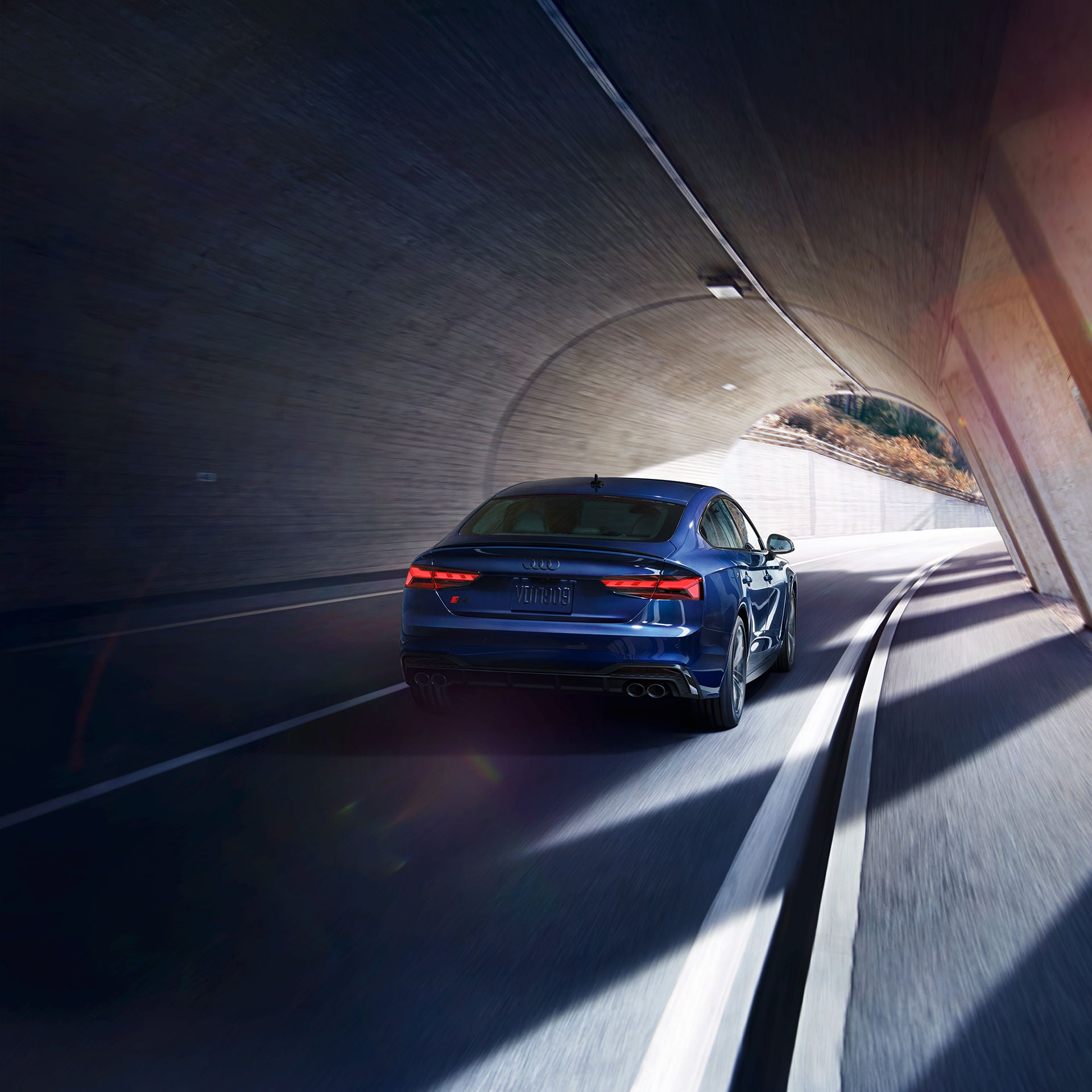 Rear view of the Audi S5 Sportback driving through a tunnel.