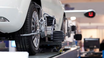 An Audi wheel getting aligned with an alignment tool.