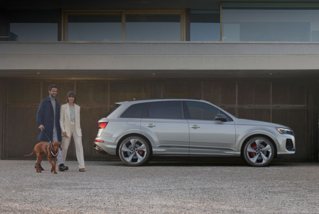 2026 Audi Q7 shown parked in front of a contemporary residence