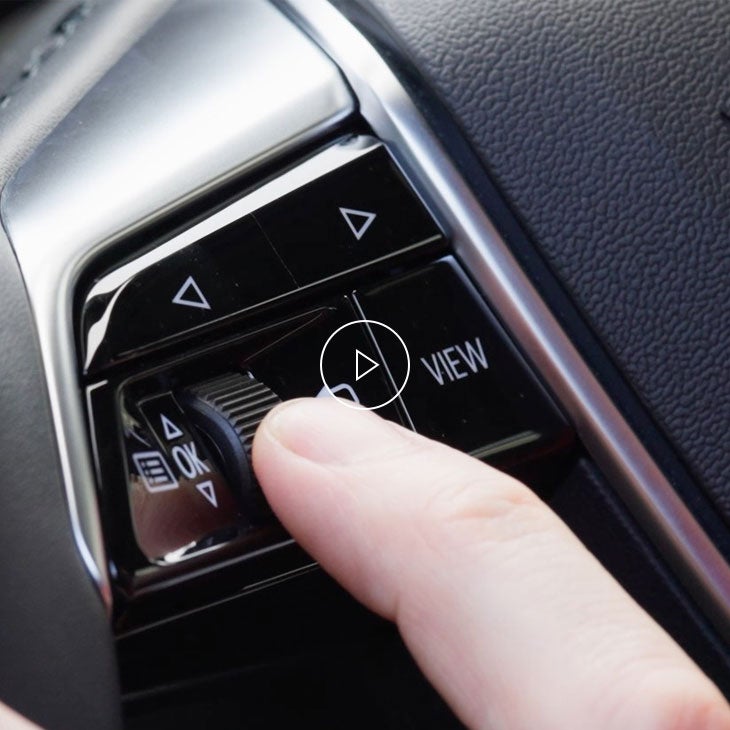 Close-up of a person flicking a switch on their vehicle's dashboard.