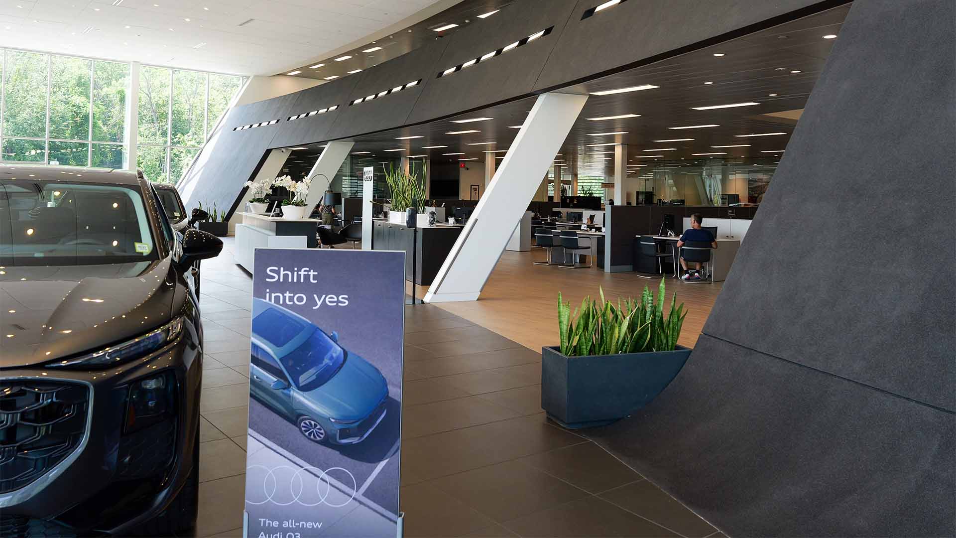 Audi Sale Specialist explaining vehicle features to a customer.