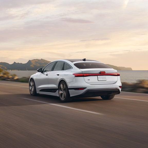 Rear 3/4 rear view of the Audi A6 Sportback e-tron in motion.