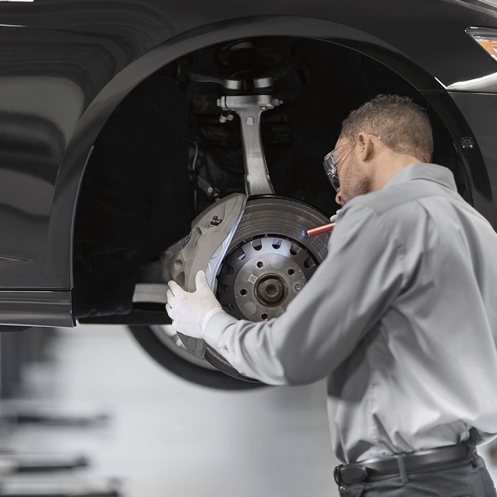 Service technician servicing a tire. 