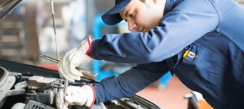 Service technician servicing vehicle.