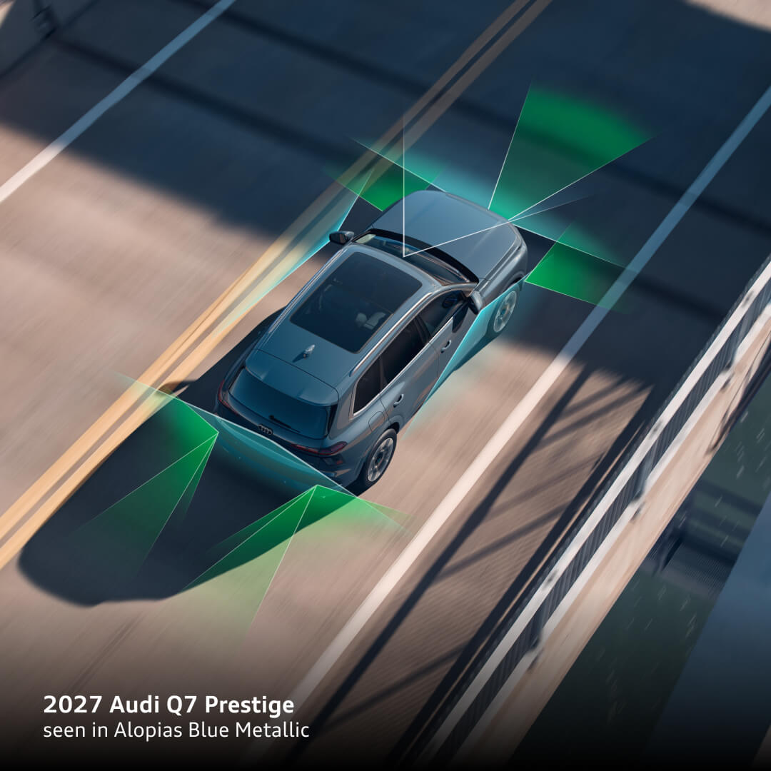 2027 Audi Q7 Prestige in Alopias Blue Metallic driving on a bridge, with driver-assistance sensor zones illustrated.
