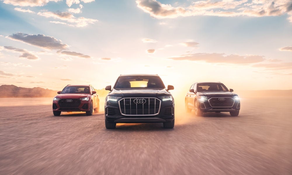 Three Audi vehicles accelerating. 