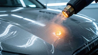 Heat gun being applied to a car hood that has paint protection film on it.