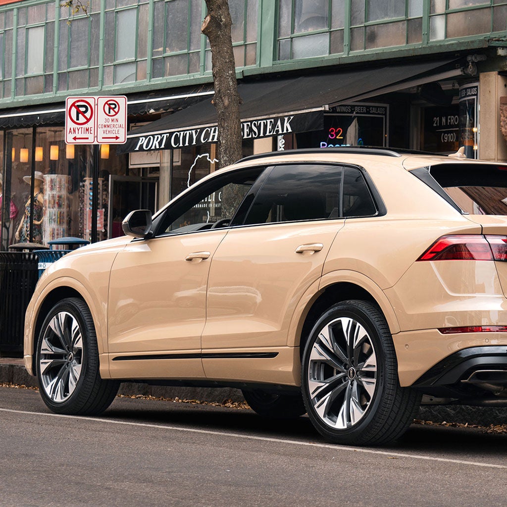 Rear profile view of an Audi Q8 parked.