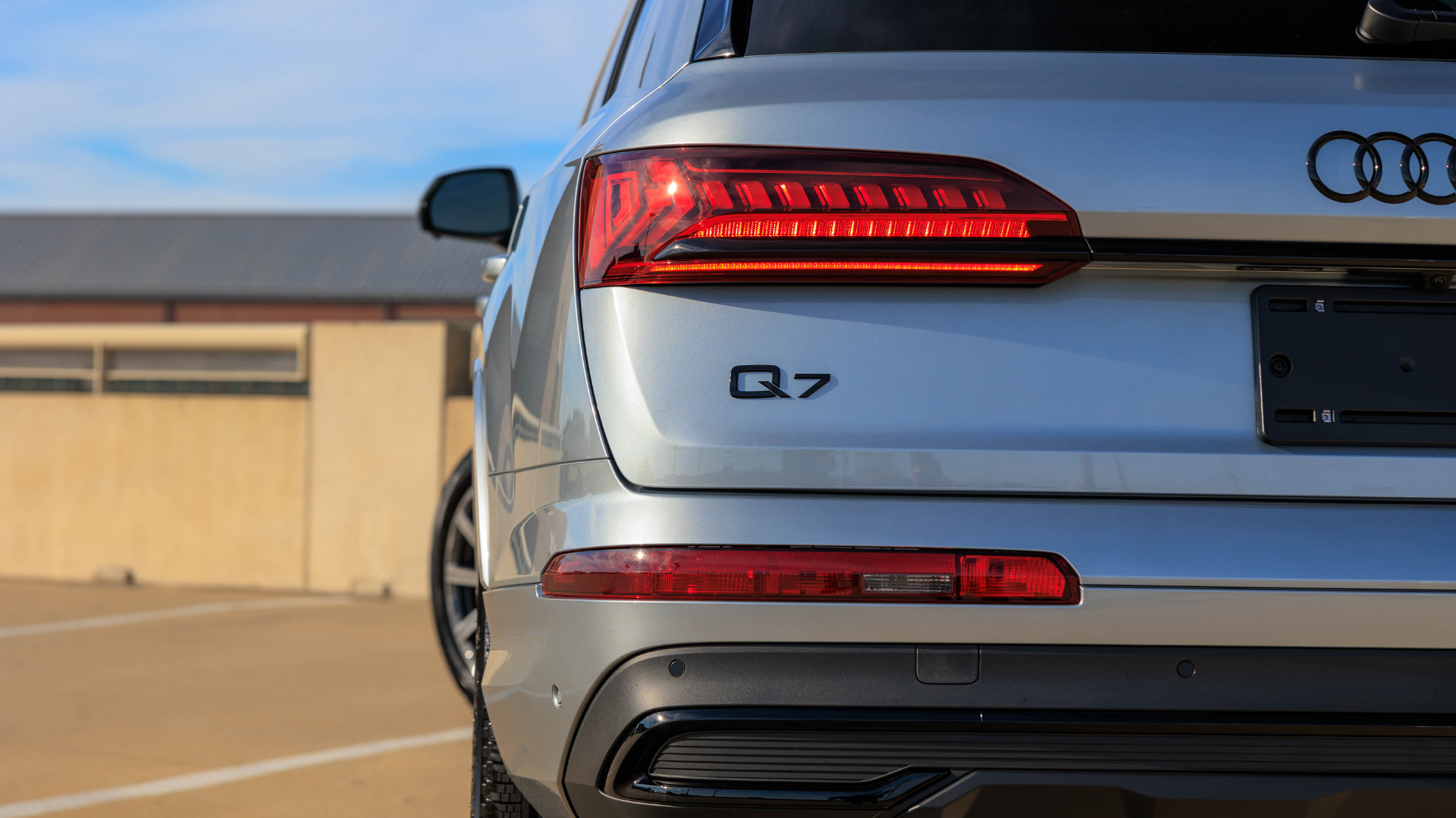 Close up of the back of a Audi Q7 SUV. The car is silver. 