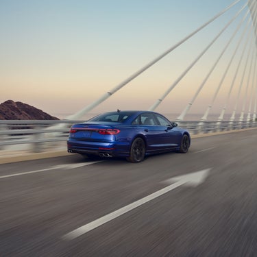 Three quarter rear view of the Audi S8 accelerating.