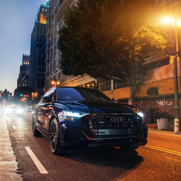 Three-quarter front view of the Audi Q8 accelerating.