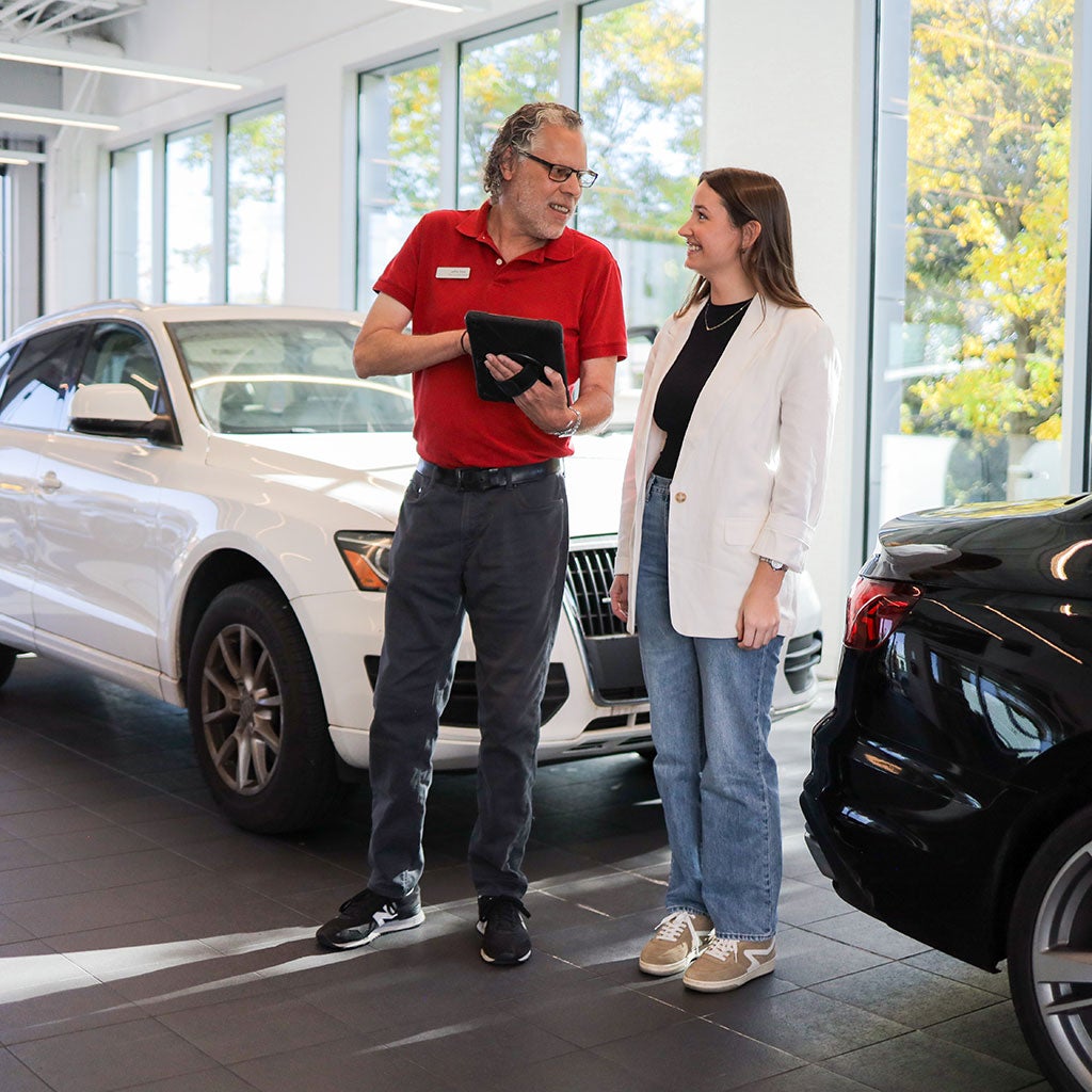 Audi employee with customer in a showroom.