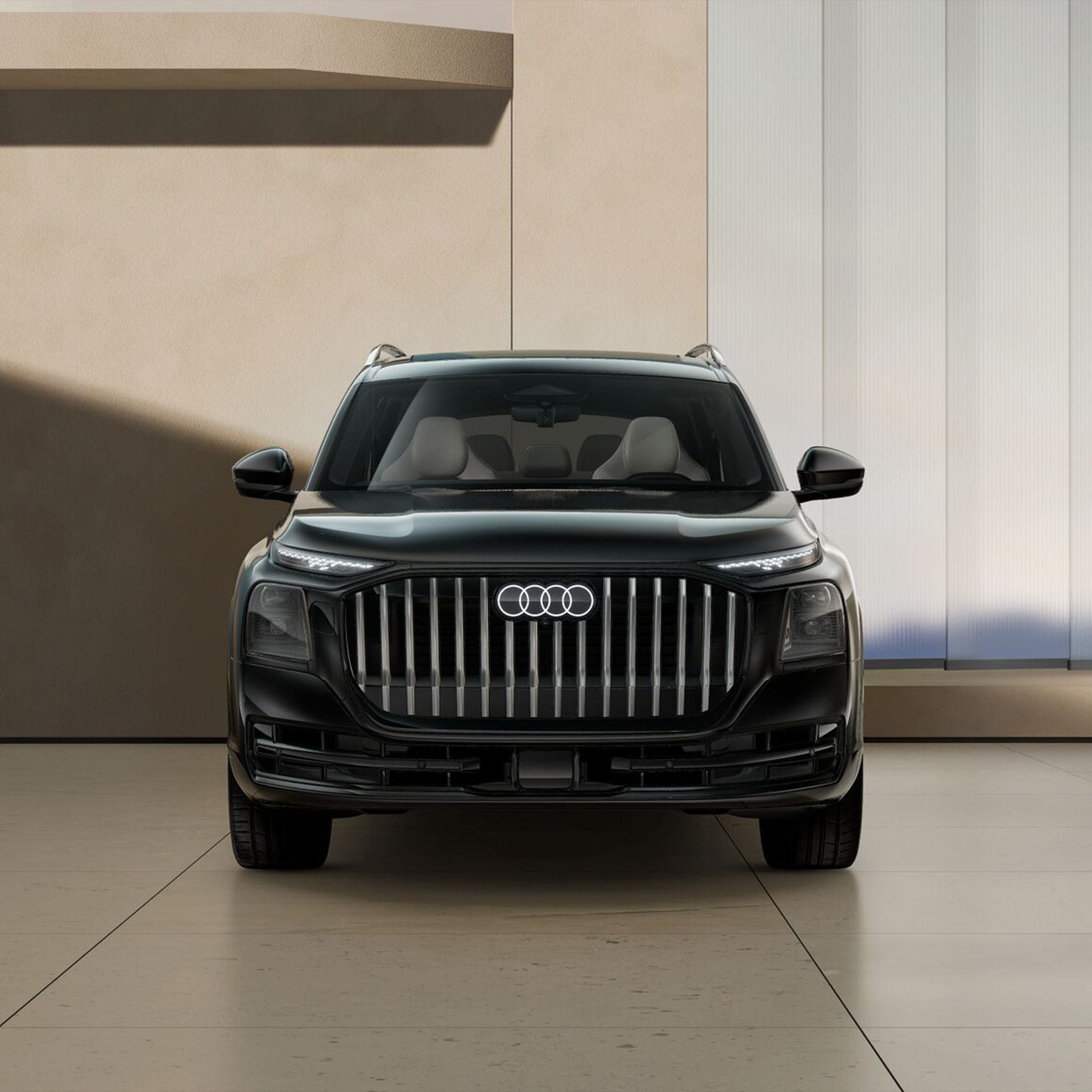 Front profile of the Audi Q9 parked in front of a tree-lined, hilly landscape.