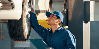 Service technicians serving vehicle.