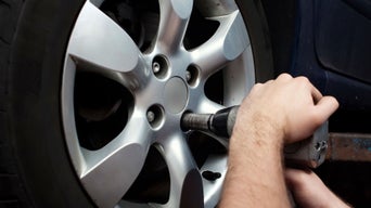 Service technician adjusting wheel.