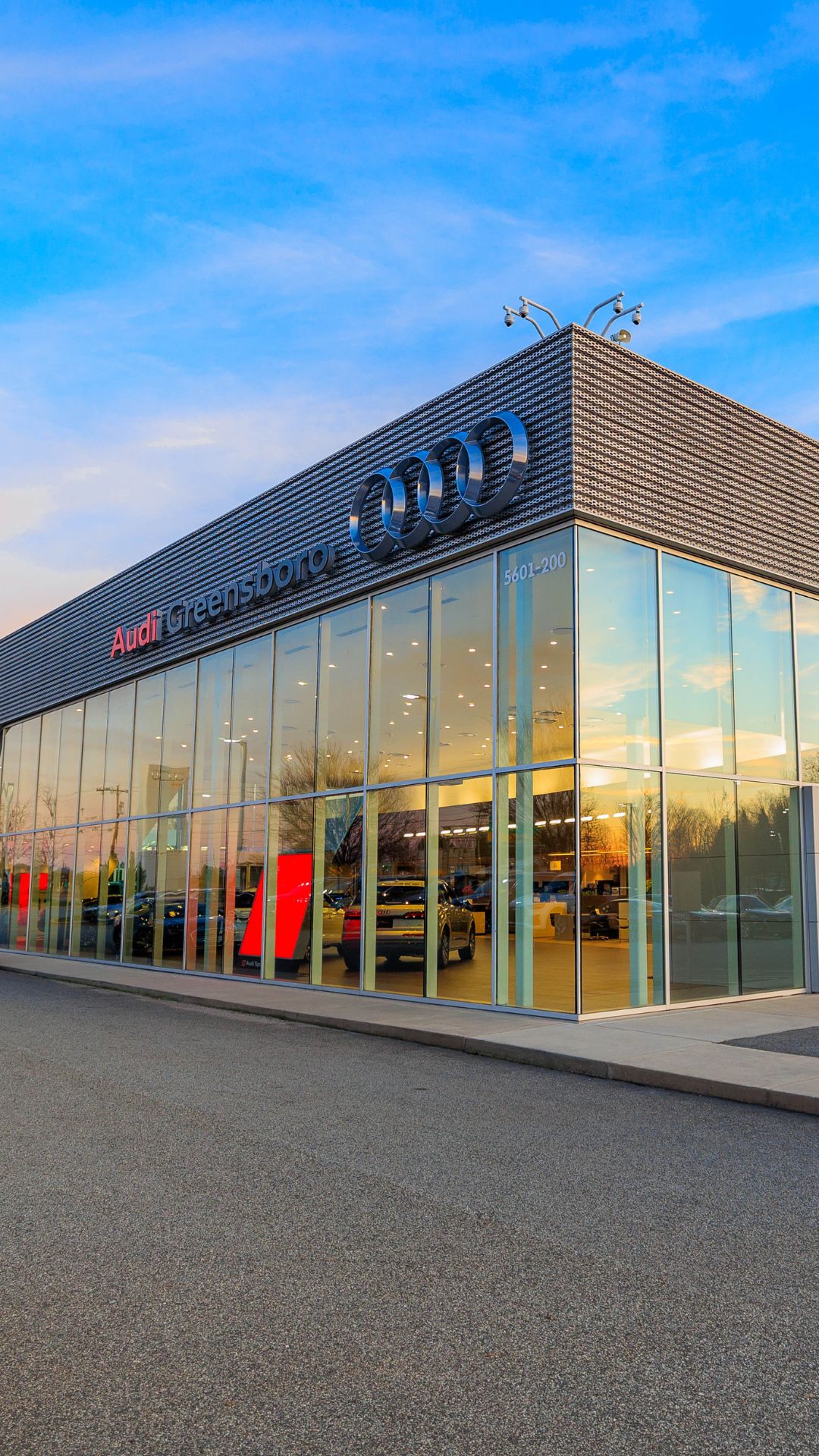 Audi Sale Specialist walking through the showroom with a couple.