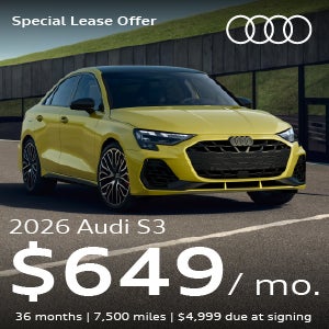 A yellow S3 parked in a parking lot.