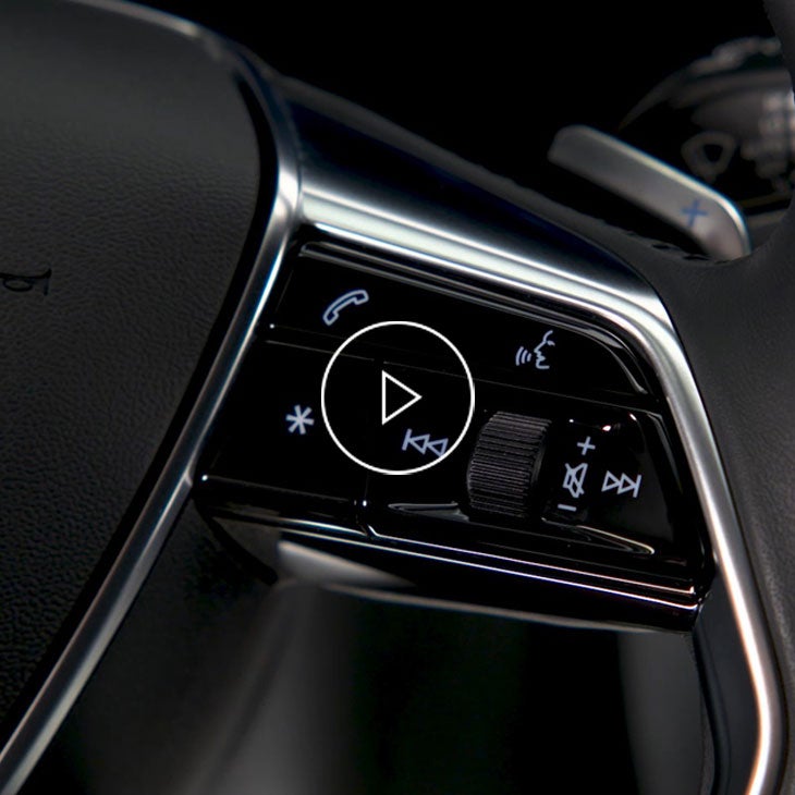  Close-up photo of the voice recognition button on the wheel of an Audi vehicle.
