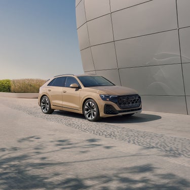 Three quarter front view of the Audi Q8 parked.