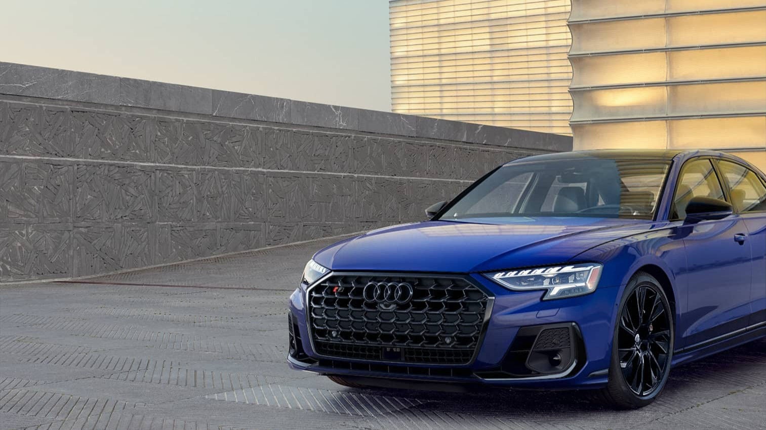 Three quarter view of an Audi A5 accelerating.