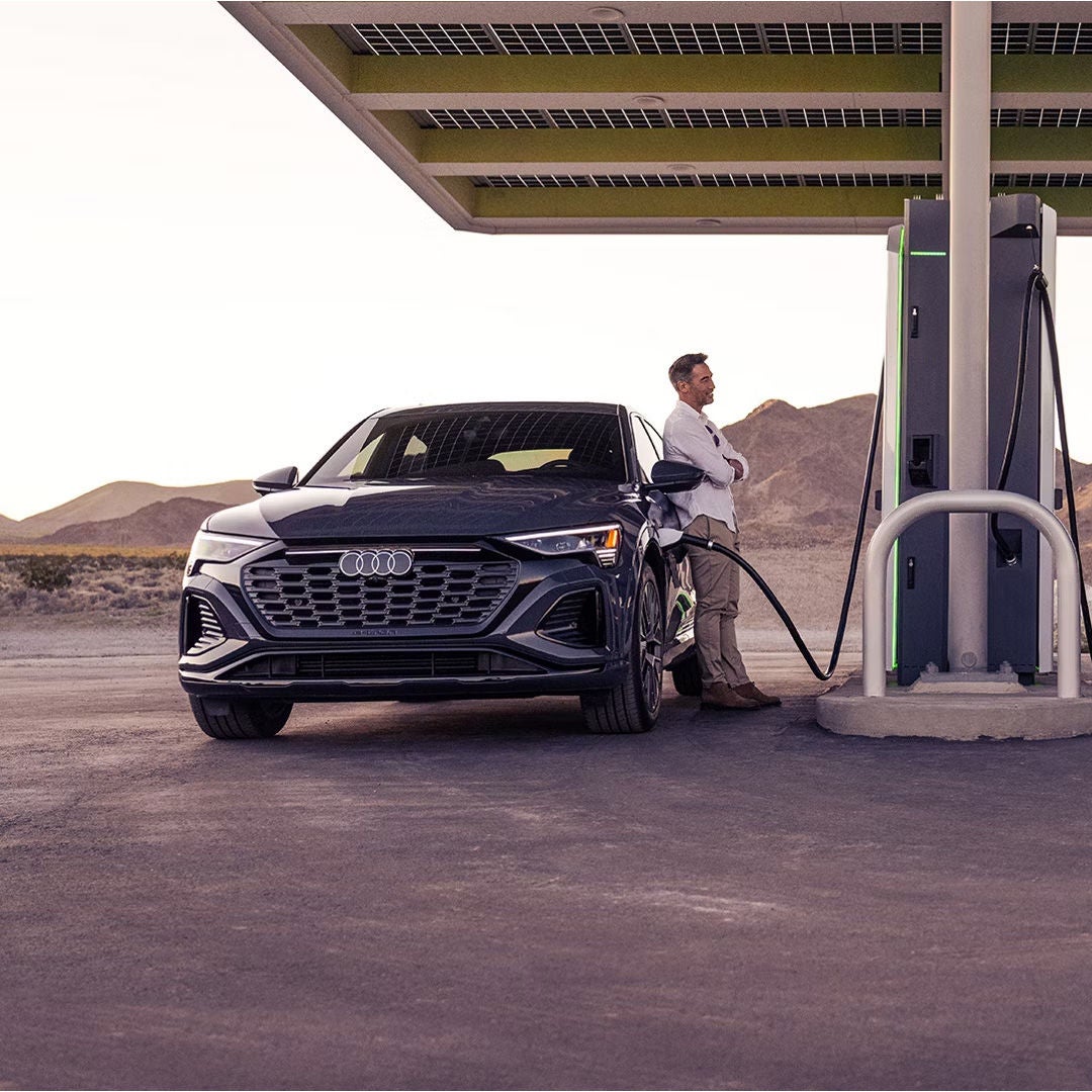 Man plugging up his Audi to charge
